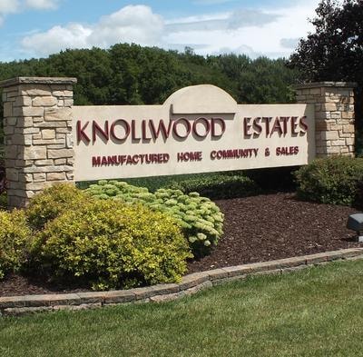 Knollwood Estates entrance sign with stone pillars and landscaping