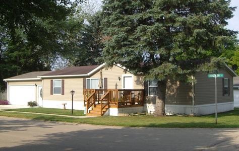 Manufactured home with wooden deck at Knollwood Estates